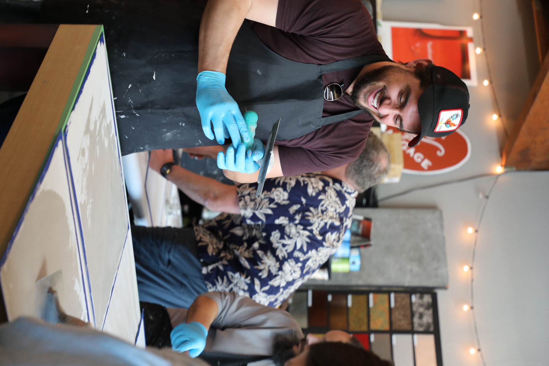 Instructor demonstrating plaster application techniques with hands-on guidance