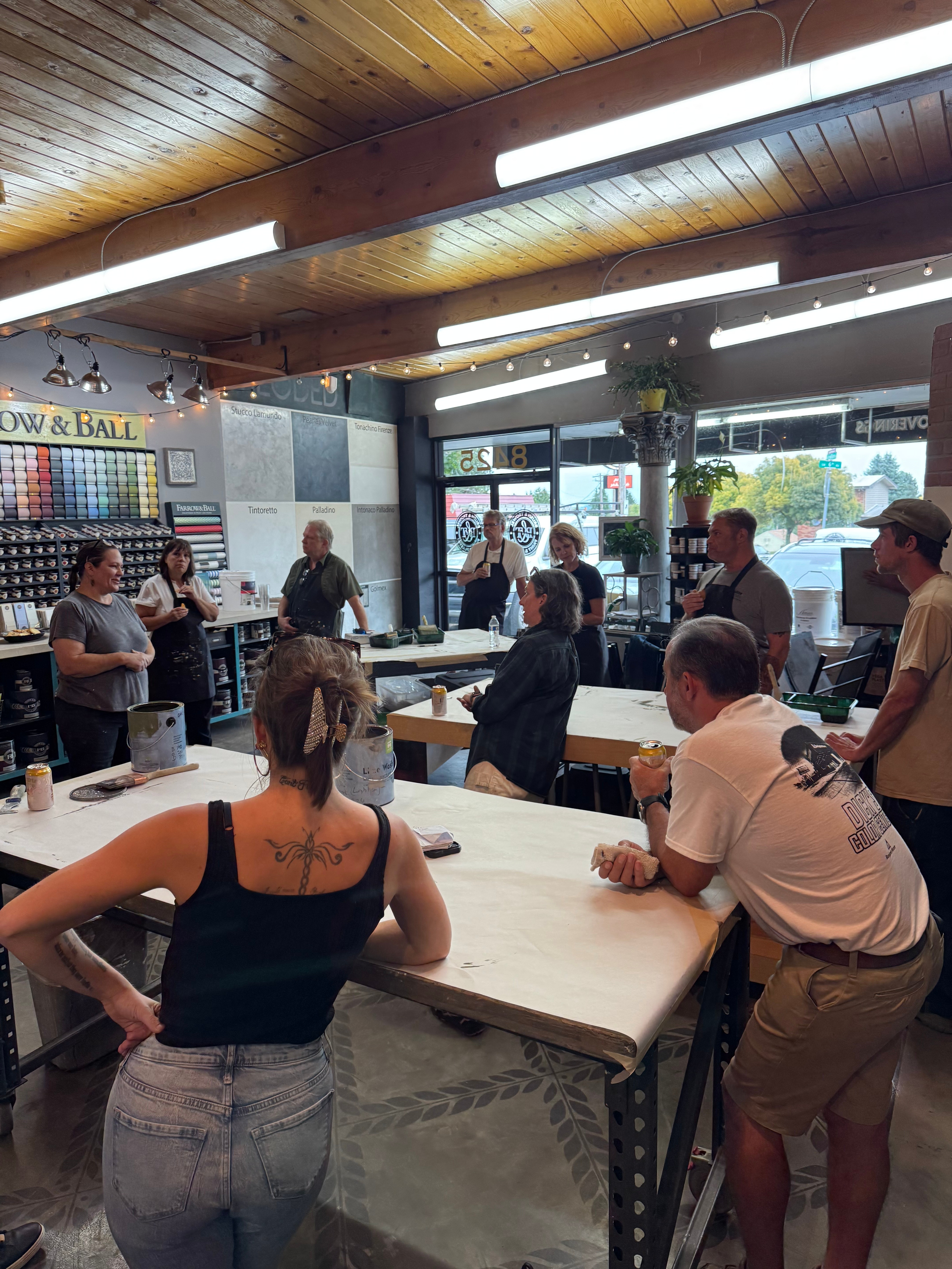 Full workshop session with students gathered around instructor demonstration